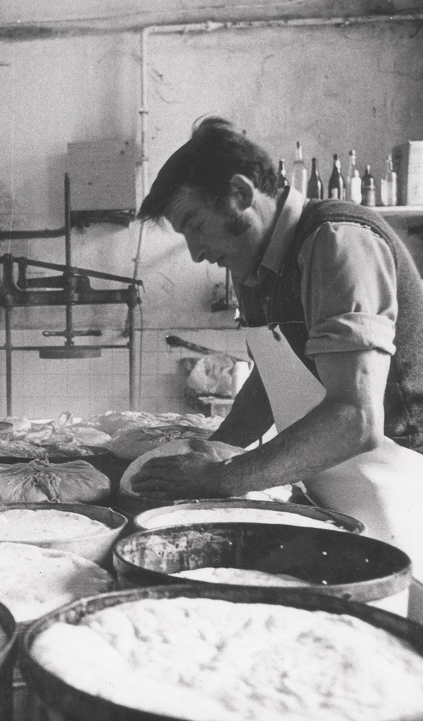 Master cheesemaker at work in the dairy, black-and-white archive photo